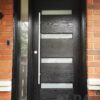 A black fiberglass entry door with one sidelight