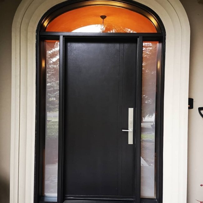 Black fiberglass door with transom.