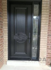 A modern black entry door with a decorative glass