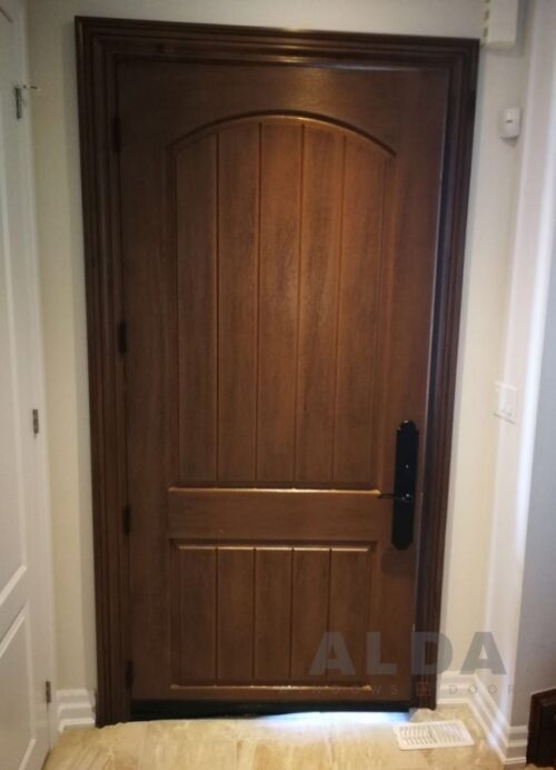 A brown, wood-style fiberglass door black handle
