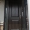 A dark brown fiberglass door with two sidelites.