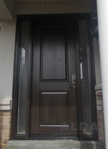 A dark fiberglass door with one sidelite.