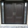 A brown fiberglass entry door with two glasses