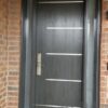 A grey fiberglass door with two glass insert.