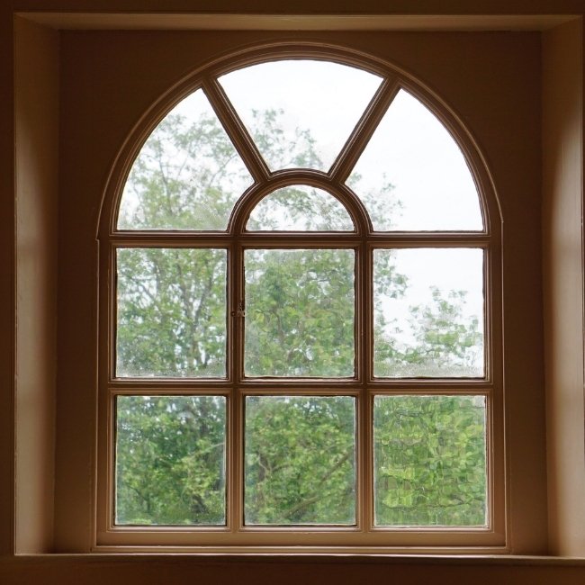 Image depicts a newly installed custom-shaped window.