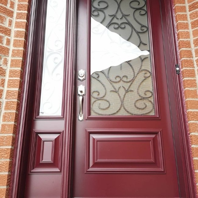 Image depicts a red steel entry door.