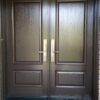 A brown fiberglass door with traditional design
