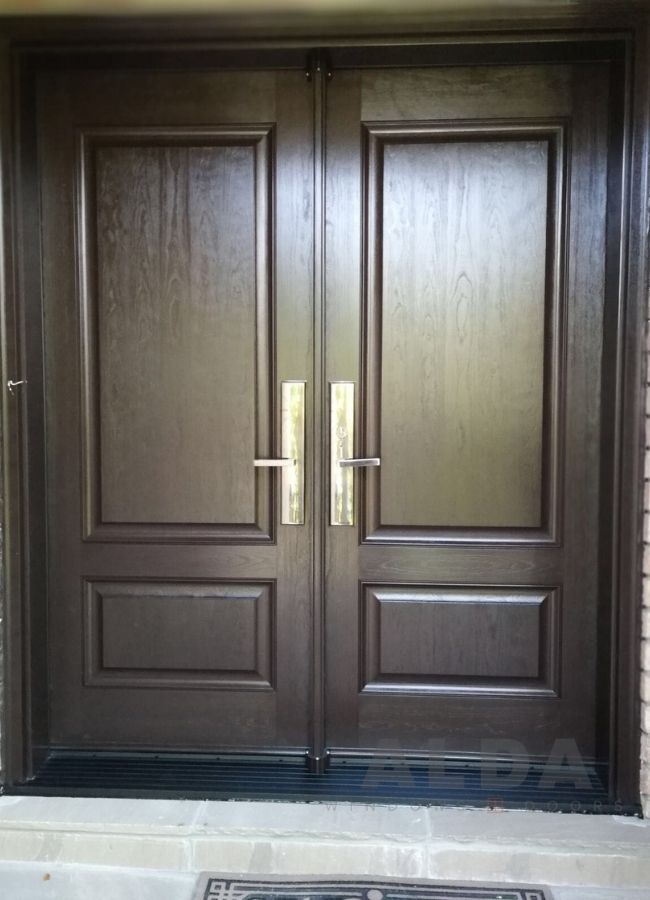 A brown fiberglass door with traditional design