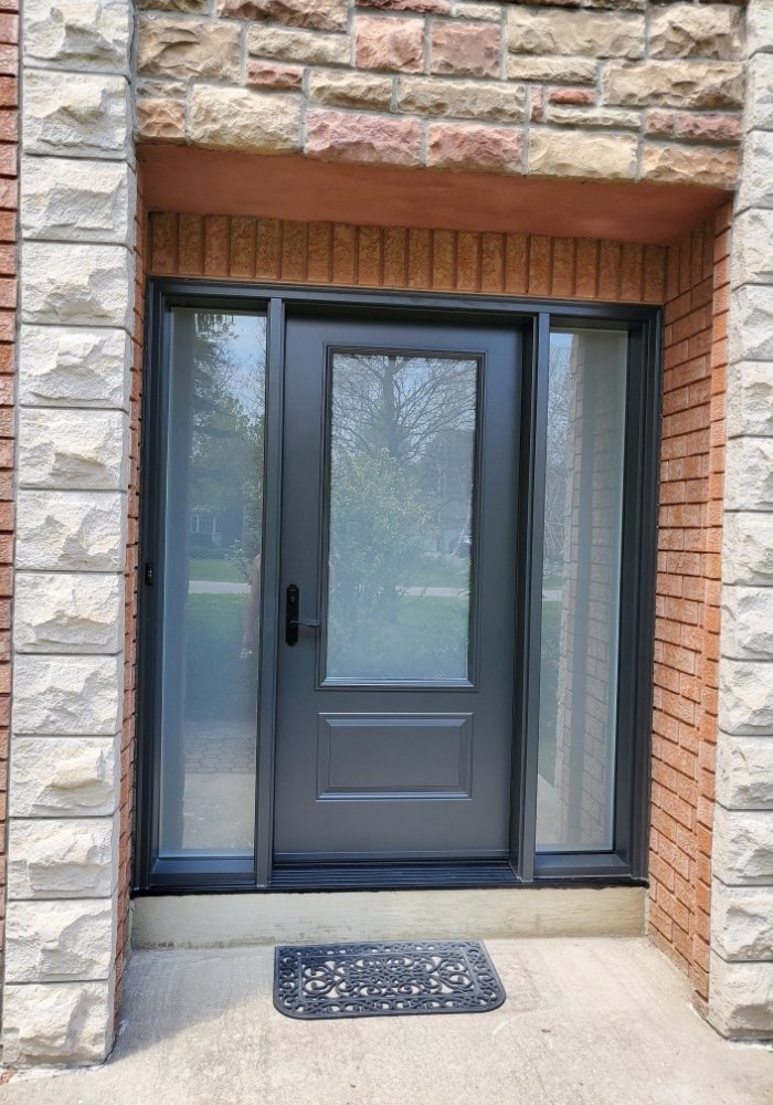 black modern front door with sidelites and glass inserts