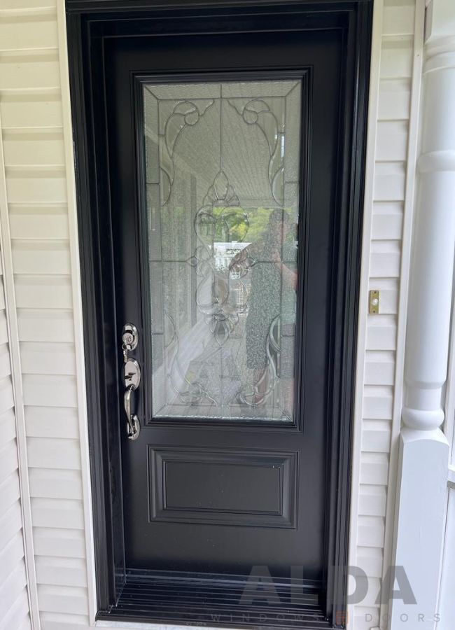 Black front door with decorative glass insert