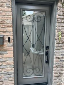 grey steel door with elegant wrought iron insert 1