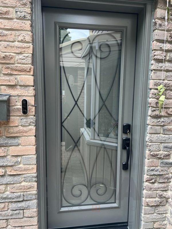grey steel door with elegant wrought iron insert