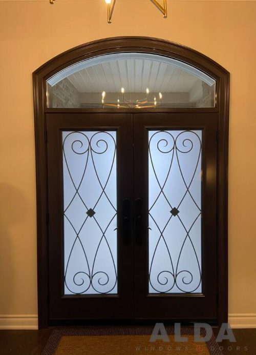 Brown fiberglass entry door with iron grills and transom