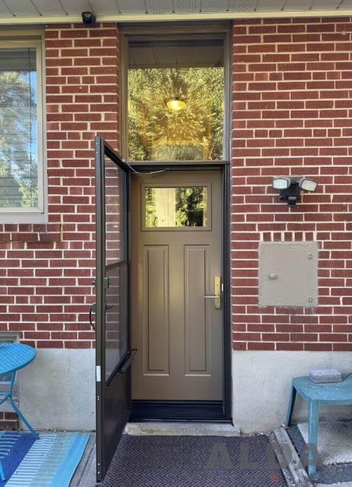 Cream front door with transom and storm door